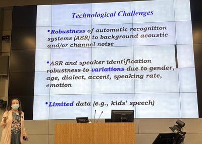 Abeer Alwan standing before presentation slide titled, Technological Challenges.